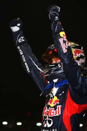 Oh what a night ... Red Bull Racing's Sebastian Vettel acknowledges fans after winning the Singapore Formula One Grand Prix last night.