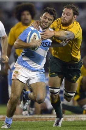 Argentina's scrum half Martin Landajo (left) is tackled by Wallabies' lock Scott Higginbotham during the last match of the Rugby Chiampionship in Rosario. Australia won 25-19 but only managed a single try.