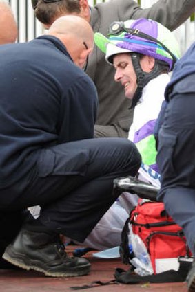 Ouch: Luke Nolen is treated after being dumped at Caulfield.