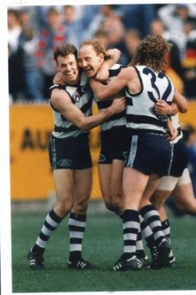 Gary Ablett is besieged by teammates Michael Mansfield (left) and Garry Hocking (right) after kicking the match winning goal.