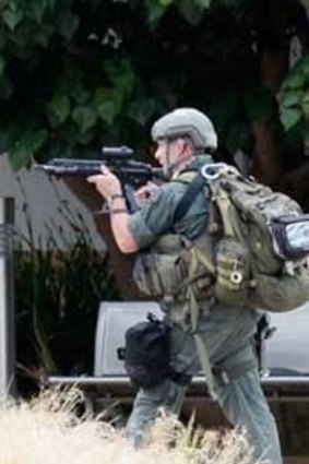 Los Angeles County SWAT team members search the grounds of Santa Monica College.