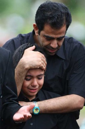 Seena, 9, grieves at the funeral for an eight-month-old baby drowned when an asylum-seeker boat broke up on rocks on Christmas Island.