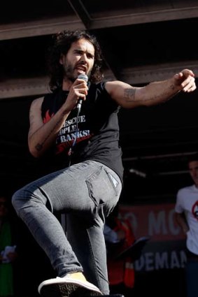 Russell Brand speaking to demonstrators that gathered in Parliament Square.The crowd marched from Oxford Circus to Parliament Square to voice their opposition to government austerity cuts.
