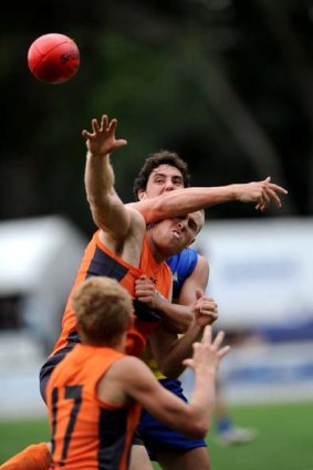 The ACT's Jye Bohm and GWS's Jonathan Giles jostle for possession during Saturday's trial match in Canberra. The AFL's new team-in-waiting went down by 12 points.