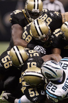 Ouch! ... New Orleans Saints defenders tackle Carolina Panthers' Tyrell Sutton in a game in New Orleans last November.