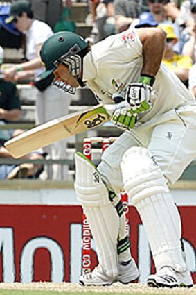 Ricky Ponting gets hit by a bouncer from Kemar Roach.