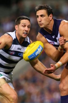 Ball-up: Docker Matthew Pavlich (right) and Geelong's Harry Taylor battle for the ball.
