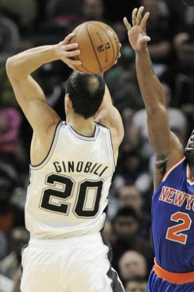 New York Knicks guard Raymond Felton tries to block  San Antonio veteran Manu Ginobili.