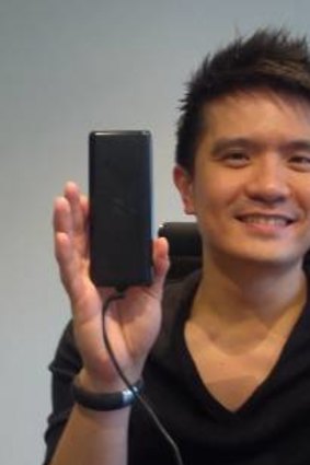 Min-Liang Tan shows off how tiny the Blade's power supply is, compared to one of Dell's.