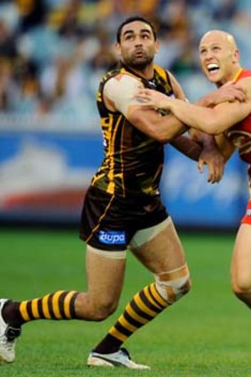 Tight tussle: Shaun Burgoyne and Gary Ablett come to grips in yesterday's game.
