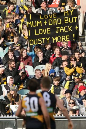 Jack Riewoldt walks back to the goal square in front of a  banner dedicated to him by a fan.