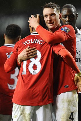 Manchester United's Phil Jones embraces teammate Ashley Young.