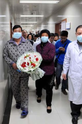 All-clear: A patient (left) from Bozhou, in central China's Anhui province, has been discharged following his recovery from the H7N9 bird flu.