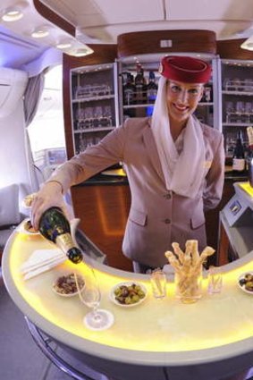 Cabin Crew serving champagne in Onboard Lounge A380, Emirates Airlines.