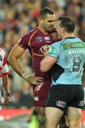 Verbal joust: Greg Inglis and Paul Gallen during a heated exchange in game one of the 2013 series, which NSW won 14-6.