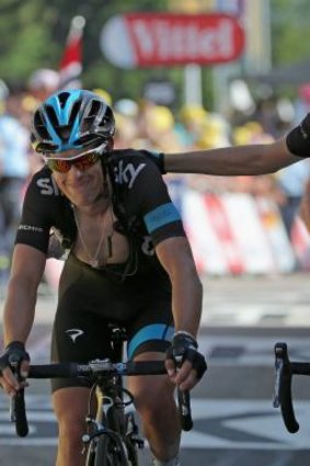 Helping hand: Richie Porte's Team Sky teammates, including Mikel Nieve Iturralde (right), dragged the Australian over the line during the 13th stage.