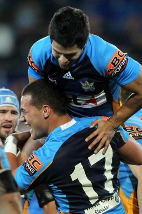 Bodene Thompson of the Titans celebrates after scoring a try.