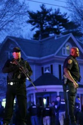 Police guard the Watertown house where Dzhokhar Tsarnaev was found.