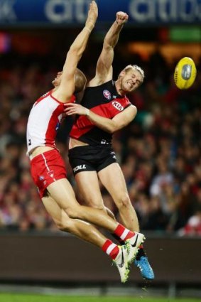 Under pressure: Swan Sam Reid is challenged by Michael Hurley at the SCG.