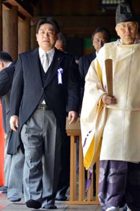 Controversial ... the Japanese Transport Minister, Yuichiro Hata, left, walks through Tokyo's Yasukuni Shrine.