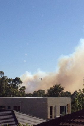Water bombers are fighting fires with water from Lake Gwelup.