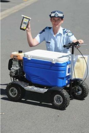 Senior Constable Kelly Miles with a motorised esky that a man was allegedly riding in public while over the limit.