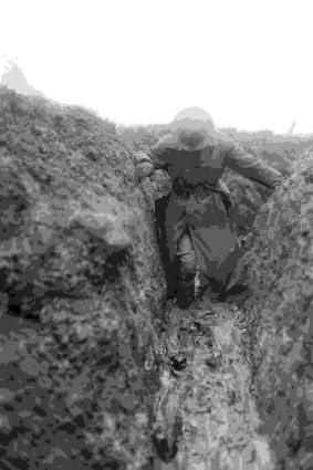 World War 1 war correspondent and historian Charles Bean knee deep in mud in a trench near Gueudecourt in France during the winter of 1916-17. 