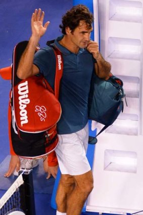 Roger Federer leaves the court after being beaten in straight sets by Rafael Nadal.
