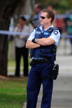 Ex-husband lay in wait ... A police officer at the scene of the Mulgrave shooting.