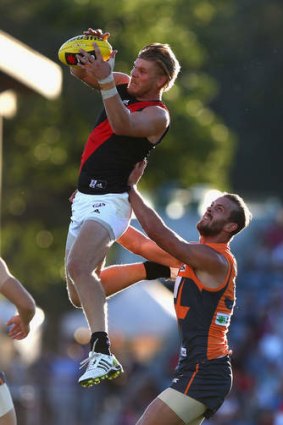 Up and away: Bomber Michael Hurley leaps for a mark against the Giants at Manuka Oval.