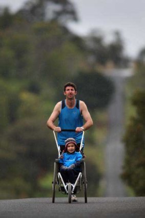 Jamie Egan pushes son Jason, 7, as they train for their 300-kilometre run from Wodonga to Melbourne.