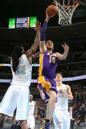 Los Angeles Lakers centre Pau Gasol drives the lane for a shot as Denver Nuggets forward Kenneth Faried and centre Timofey Mozgov move in.