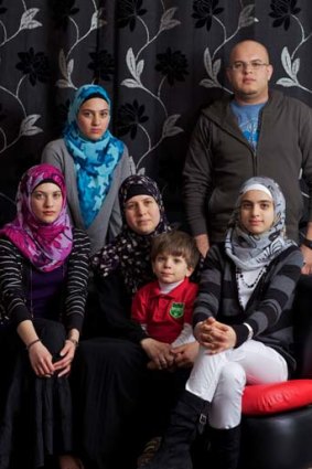 Support from Australia ... Asma Zaki Elsaed, centre, with her children, from left, Alaa, seated 18, Aya, 20, Omar, 3, Noor, 12, and Osama, 23, in their Greenacre home.