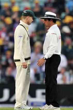 Australian captain Michael Clarke argues with umpire Aleem Dar after bad light stops play.