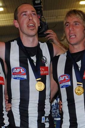 Nick Maxwell and Dale Thomas with teammates in rooms after winning the 2010 grand final.