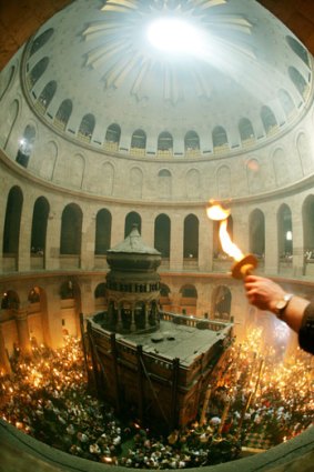 Orthodox worshippers light candles in the Church of the Holy Sepulchre, where tradition says Jesus was crucified and buried.