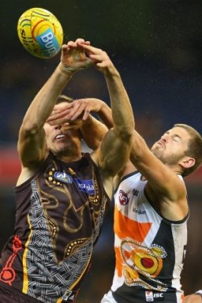 Jonathon Ceglar of the Hawks and Callan Ward of the Giants compete for a mark.