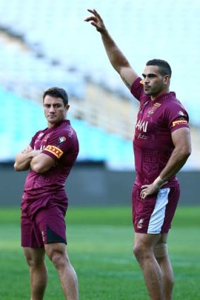 Cooper Cronk and Greg Inglis look on during a Queensland training session.