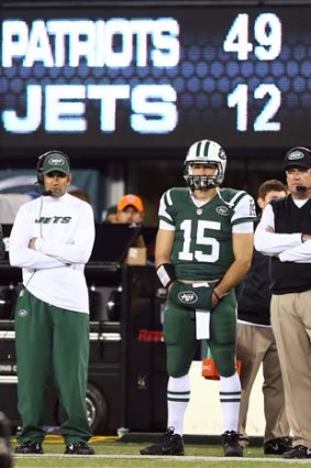 Tim Tebow stands next to head coach Rex Ryan of the New York Jets late in the fourth quarter against the New England Patriots.