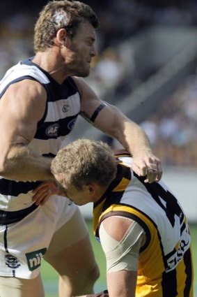Hawthorn's Rick Ladson is hit late by Geelong's Cameron Mooney.