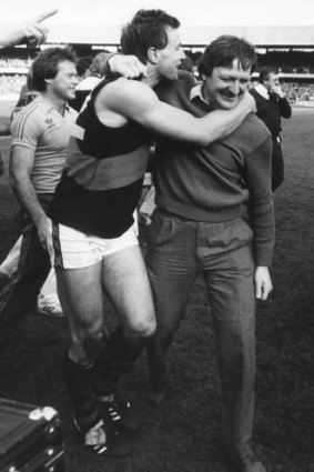 Youthful Bombers veteran Tim Watson hugs coach Kevin Sheedy after Essendon's premiership win, 30th September 1984.