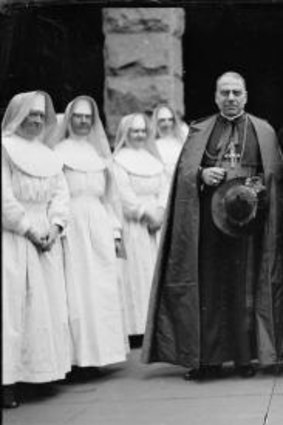 Archbishop Mannix and Cardinal Carretti standing with a group of nuns, New South Wales, circa 1930.