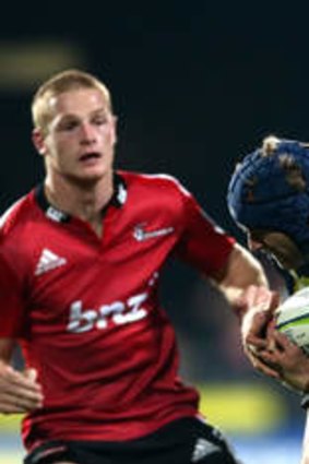 Pat McCabe of the Brumbies is tackled by Israel Dagg of the Crusaders.