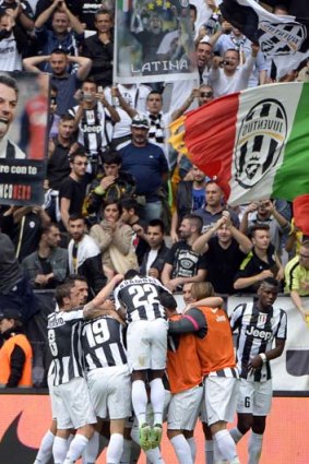 Jubilation: Juventus' midfielder Arturo Vidal, centre, celebrates with teammates after scoring the decisive penalty.