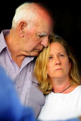 Family support ... Inspector Anderson's father, Rex, comforts his widow, Donna.