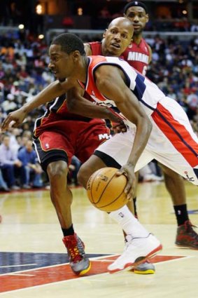 Jordan Crawford of the Washington Wizards drives to the basket as Ray Allen of the Miami Heat tries to stop him.