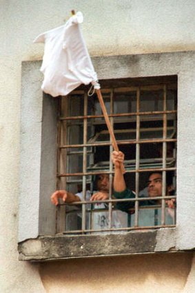 Inmates waving white flags out the window of a cell block inside the Carandiru prison in 2001.