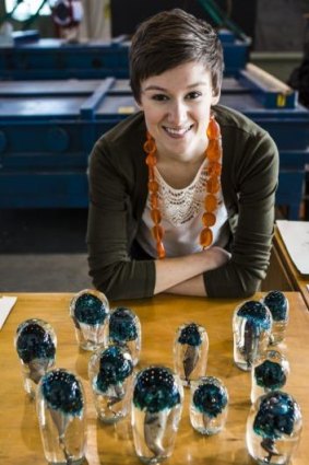 Canberra Glassworks artist-in-residence Emilie Patteson with the piece <em>Mushrooms</em>, created with Annika Romeyn.