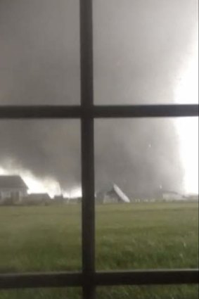 A tornado rips through Washington, Illinois on Sunday in a video still taken by resident Anthony Khoury. A fast-moving storm system spawned multiple tornadoes in Illinois and Indian killing six and causing widespread damage..