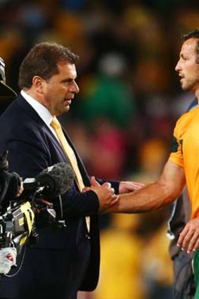 Socceroos coach Ange Postecoglou with Lucas Neill.
